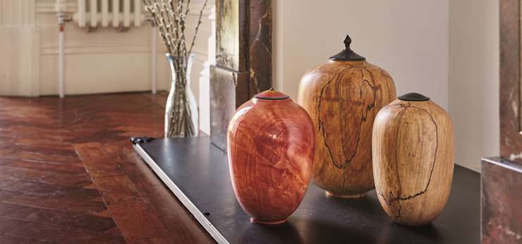 3 wooden urns on a fire place.