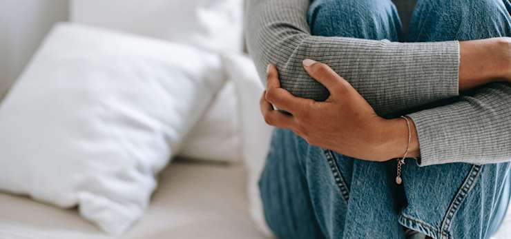 Woman sat on bed - Photo by Alex Green from Pexels