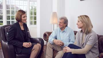 Funeral arranger sitting with a family in their home.