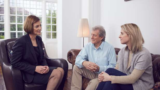 Funeral arranger sitting with a family in their home.