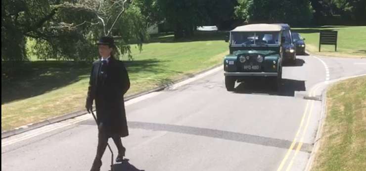 Funeral arranger leading a funeral procession.