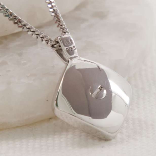 Square silver pendant with a small silver screw in the centre on a chain