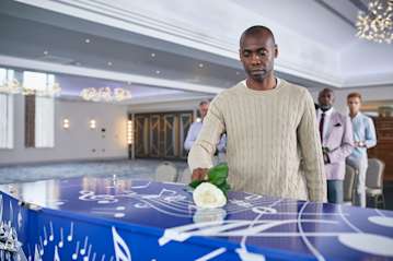 Laying flower on a bespoke coffin.