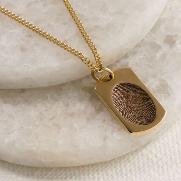 Gold fingerprint pendant on a chain