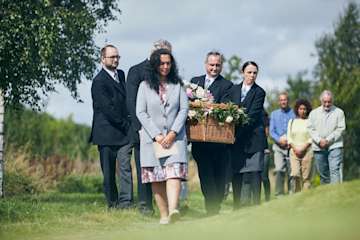Funeral procession through a field