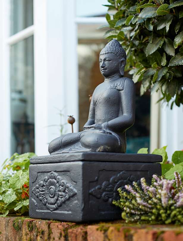 Buddha on Plinth in a garden