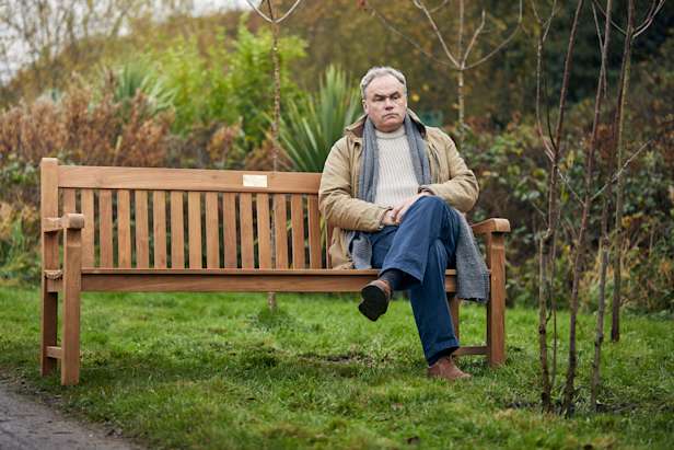 Man sat on a memorial bench