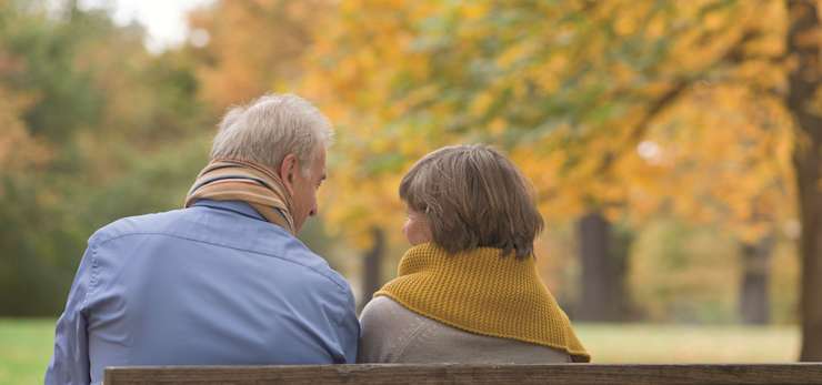 A couple having a conversation on a bench