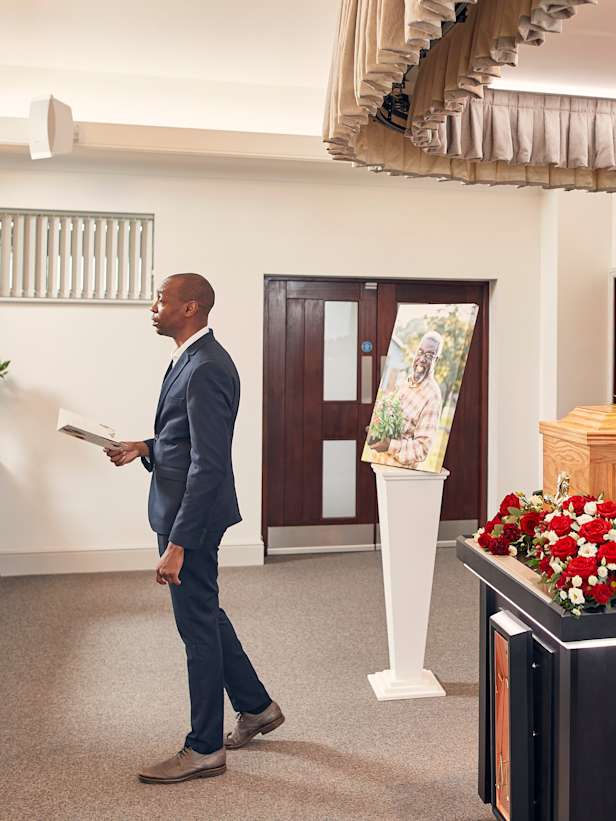 Canvas next to a coffin at a funeral