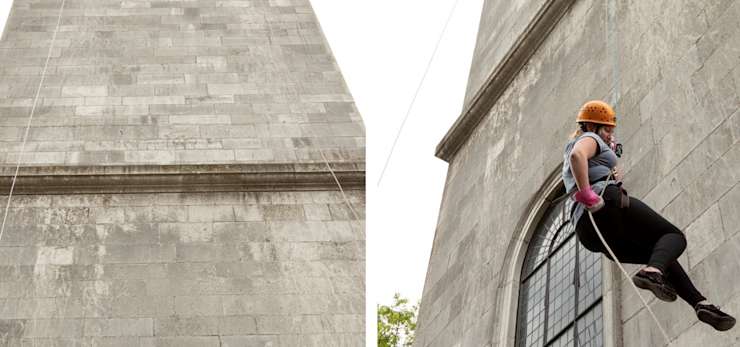 Funeral arranger abseiling down a monument.