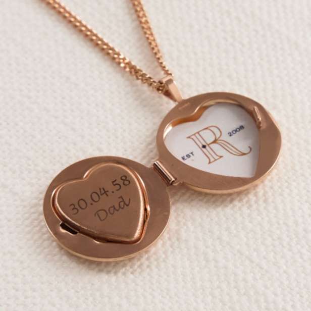 Copper coloured circular locket on a chain engraved with a date and name