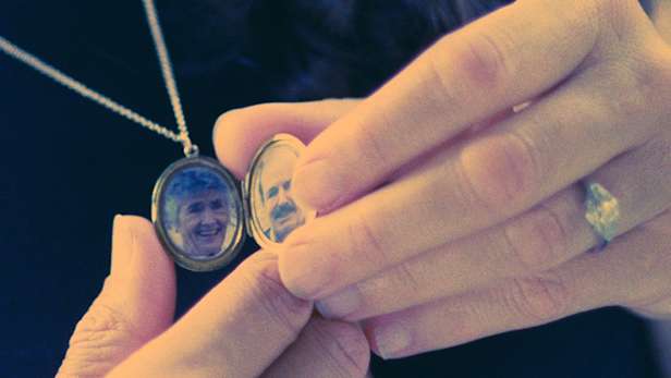 A locket necklace with pictures on