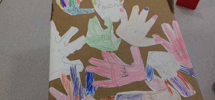 Children's collage of hand designs.