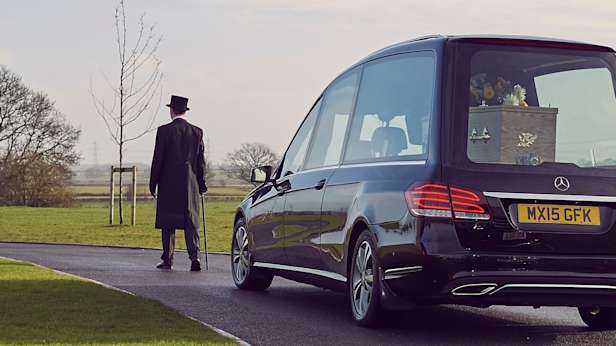 Funeral director and hearse