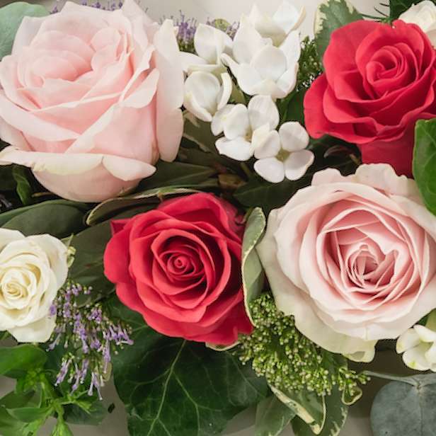 Close up of floral arrangement with light and dark pink roses