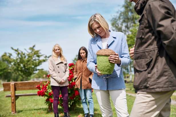 Acorn urn being held by family member