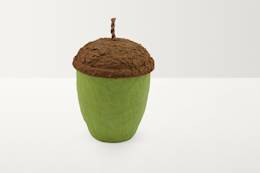 A textured urn shaped like an acorn. The top is brown and the bottom is green.