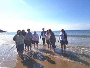 Bereavement group beach walk in the sun.