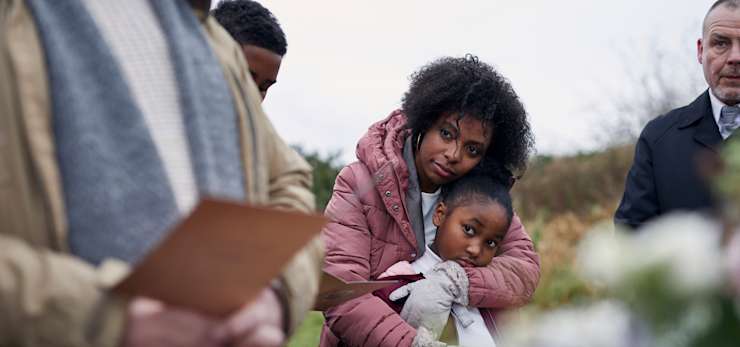 Family attending a funeral service outside