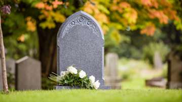 Natural grey headstone in a cemetery.