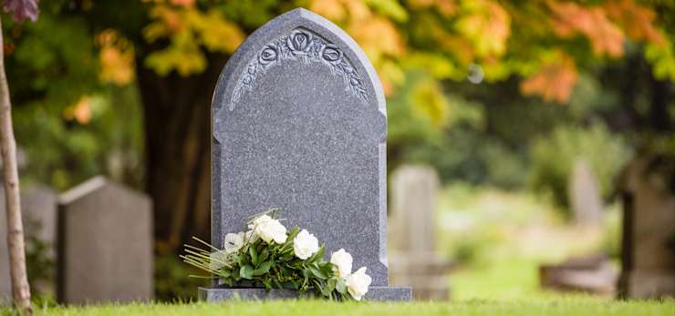 Natural grey headstone in a cemetery.