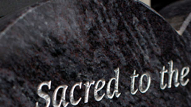memorial lettering inscriptions on a black headstone