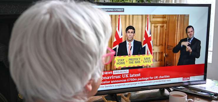 Women watching coronavirus update on TV