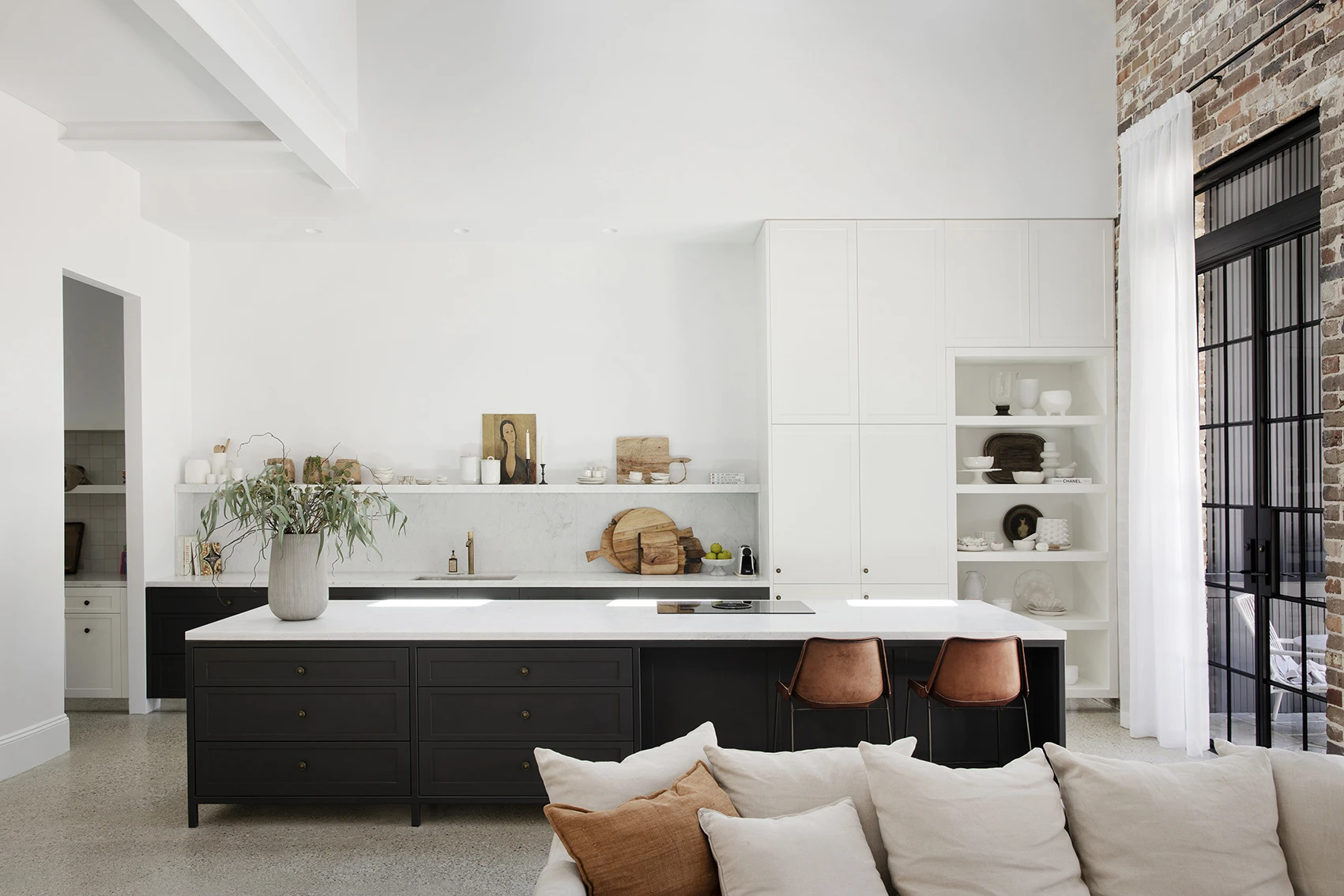 White kitchen with black island bench