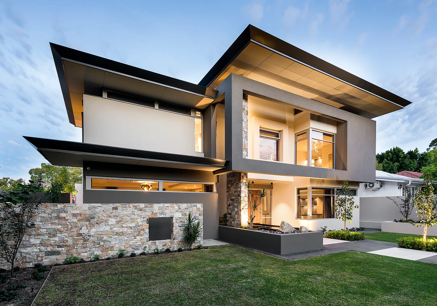 Angular double-storey house in browns and neutrals.