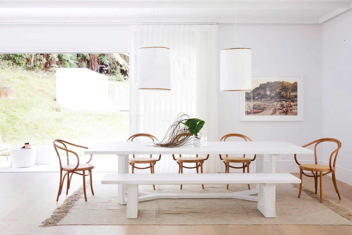interior white dining with big window and wooden chairs.