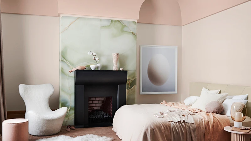 interior bedroom pink and green with fireplace.