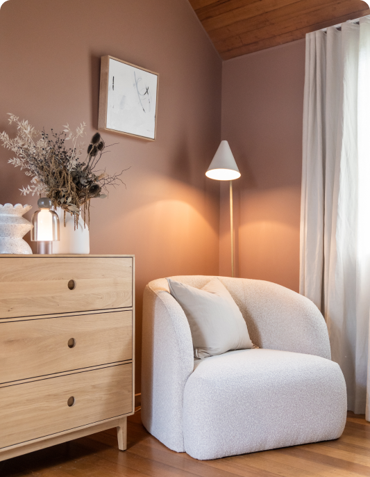 Armchair and chest of drawers in brown bedroom