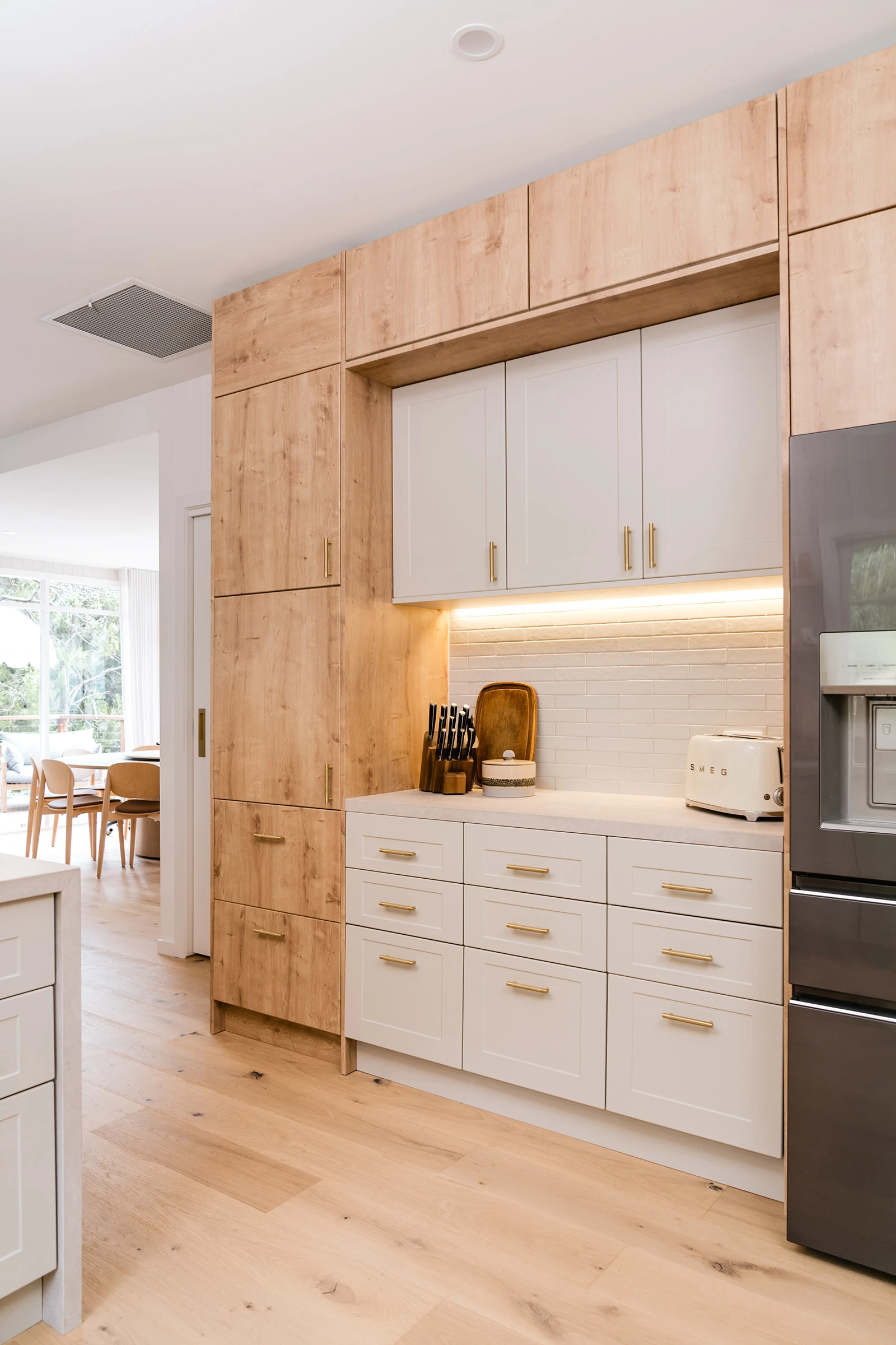 Neutral kitchen with timber cabinetry and white drawers