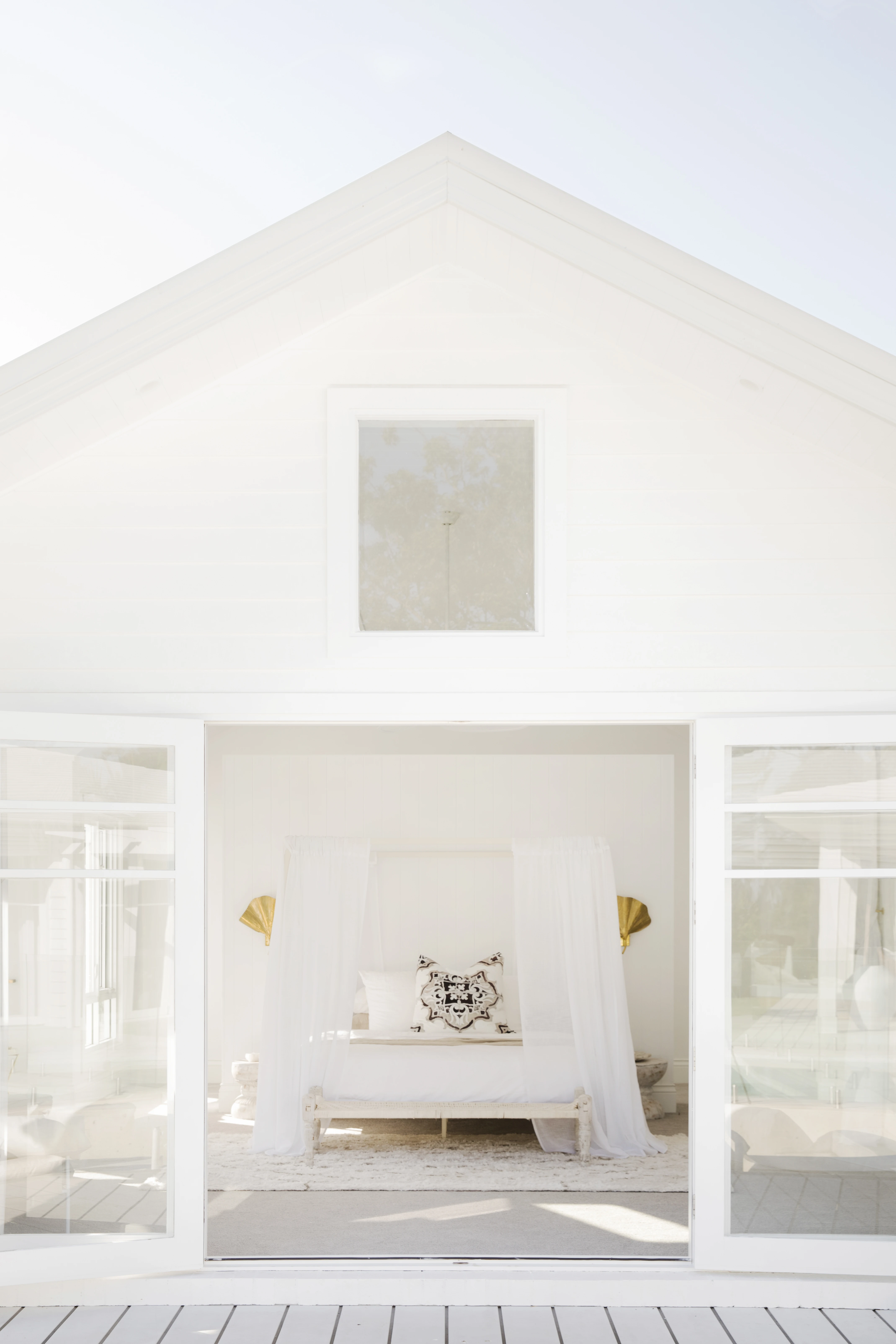 White house with indoor outdoor flow to bedroom