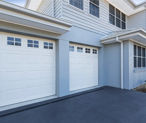 Popular outside schemes, refreshed garage doors, weatherboard house with blues greys and white double garage doors