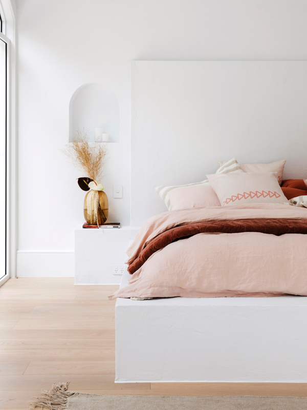 Hinterland Hideaway by Three Birds Renovations master bedroom in Dulux White on White with pink linens