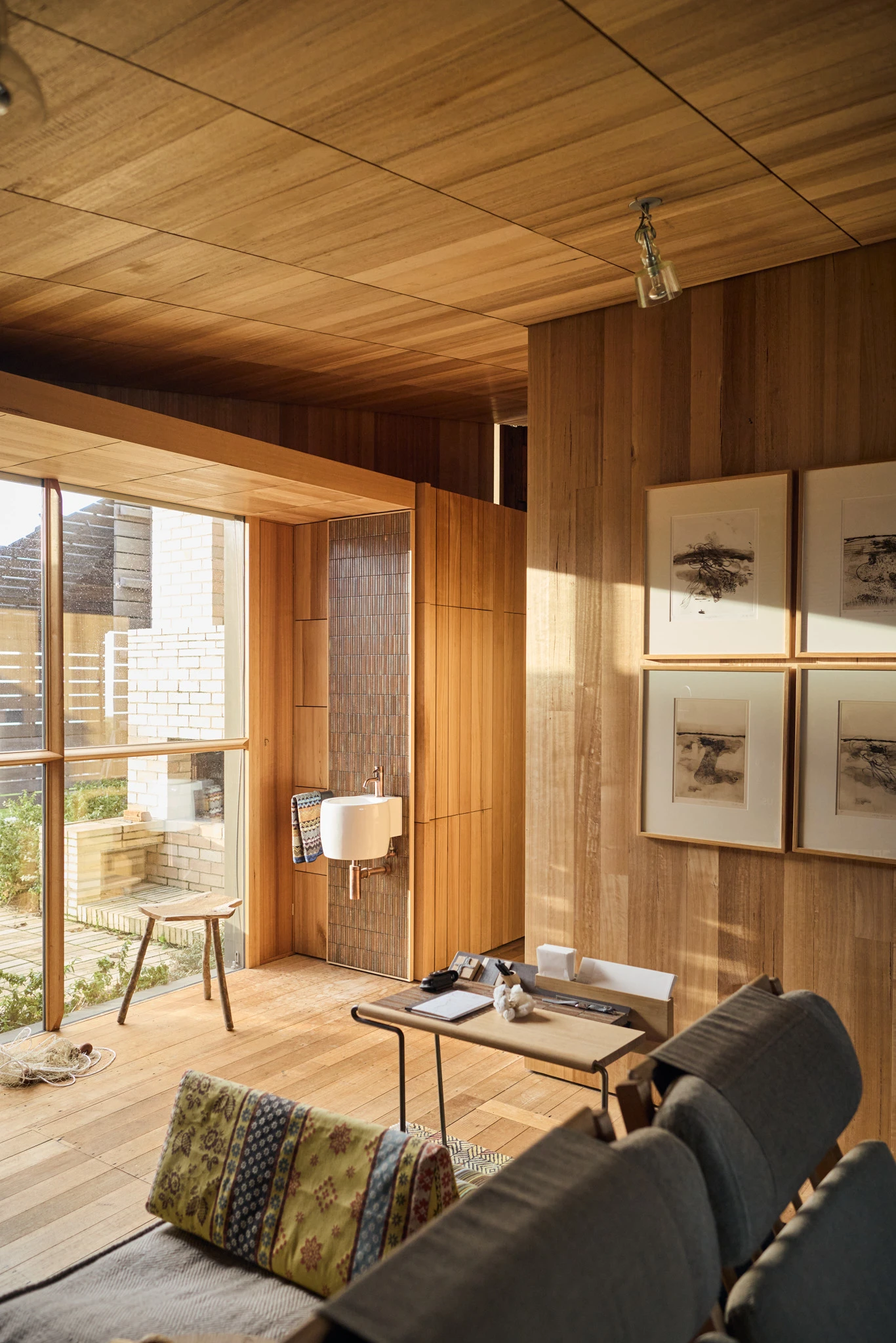 Timber living area with artwork on walls