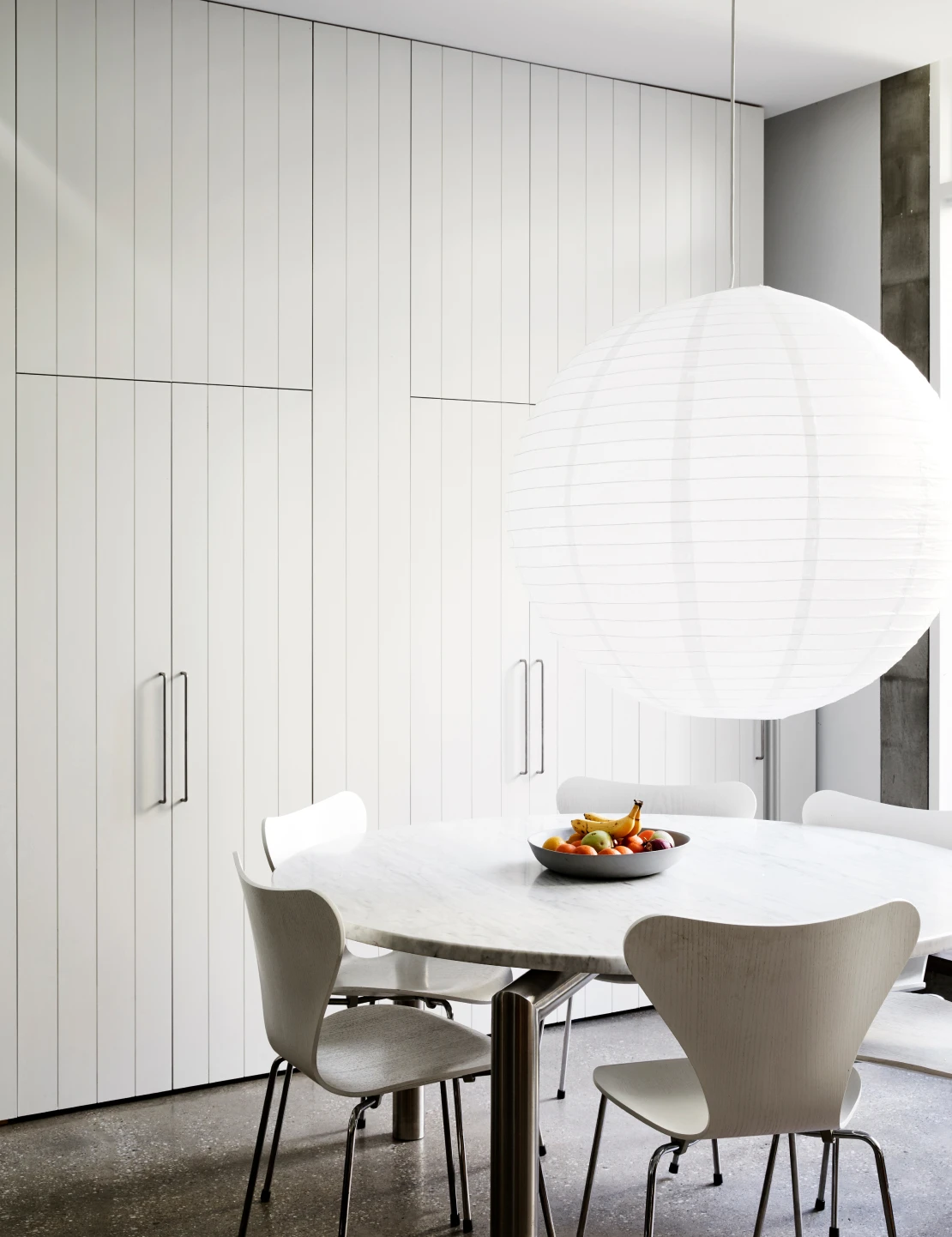 Dining room with Lexicon coloured walls, large white paper light and marble table