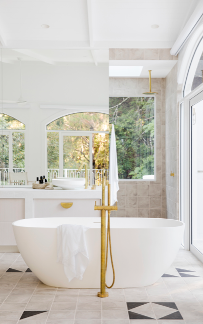 Hinterland Hideaway master bathroom with free standing bath and gold fixtures