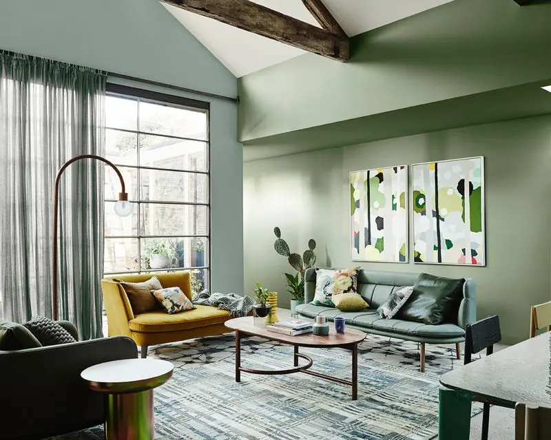 Spacious interior living room decorated with multiple green tones