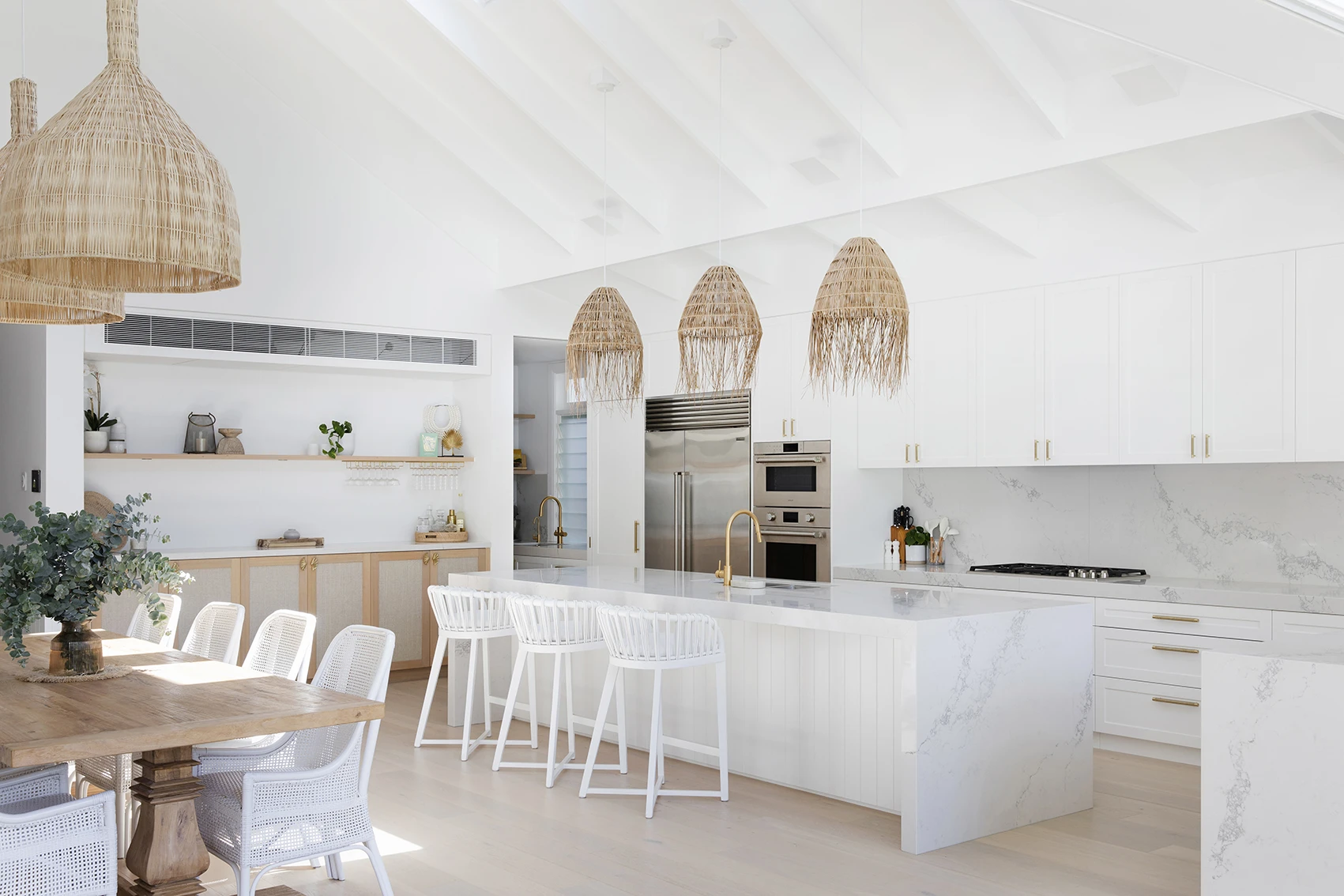 Open plan kitchen, dining with white pitchen ceiling.