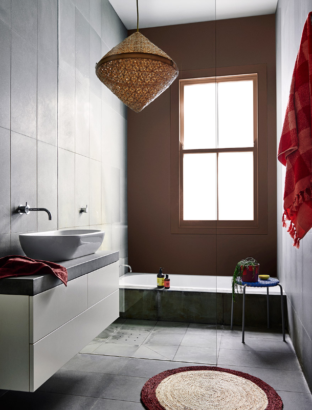 Grey and brown bathroom with wicker pendant light
