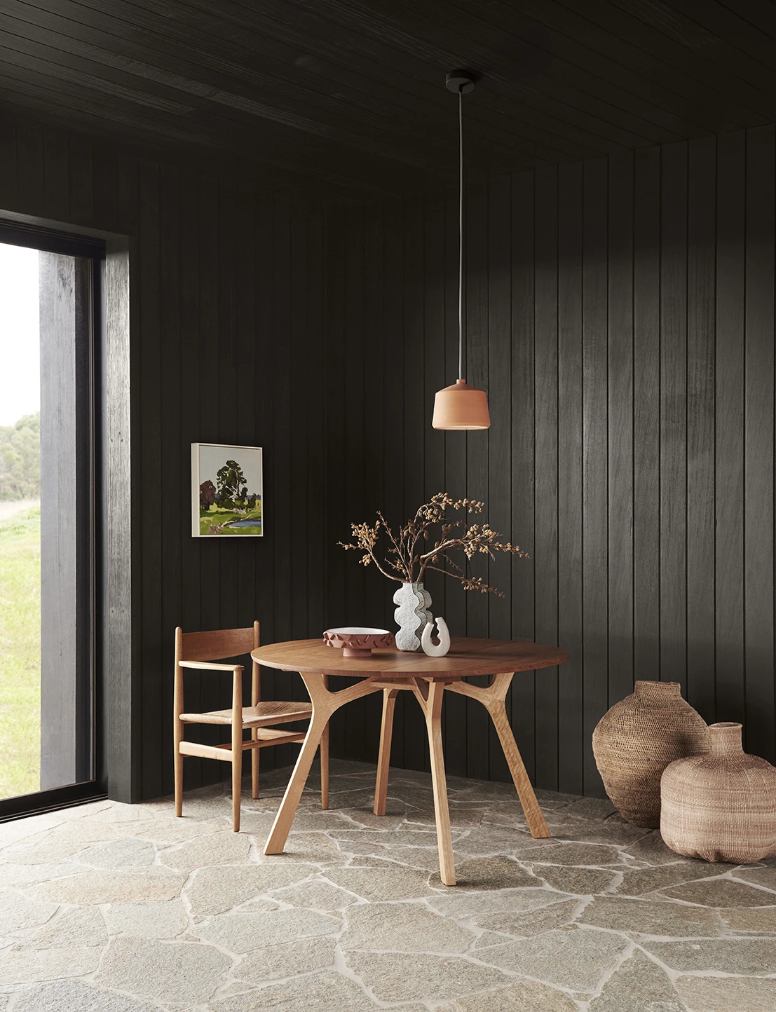 Earthy dining room with black paneled wall