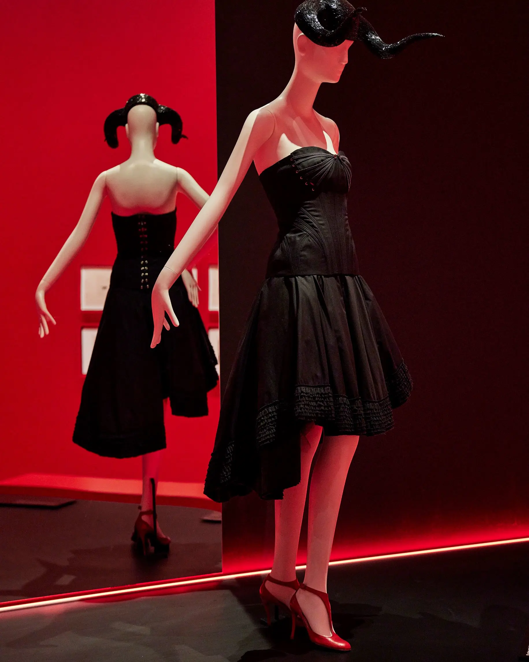 NGV Alexander McQueen black dress against black and red wall