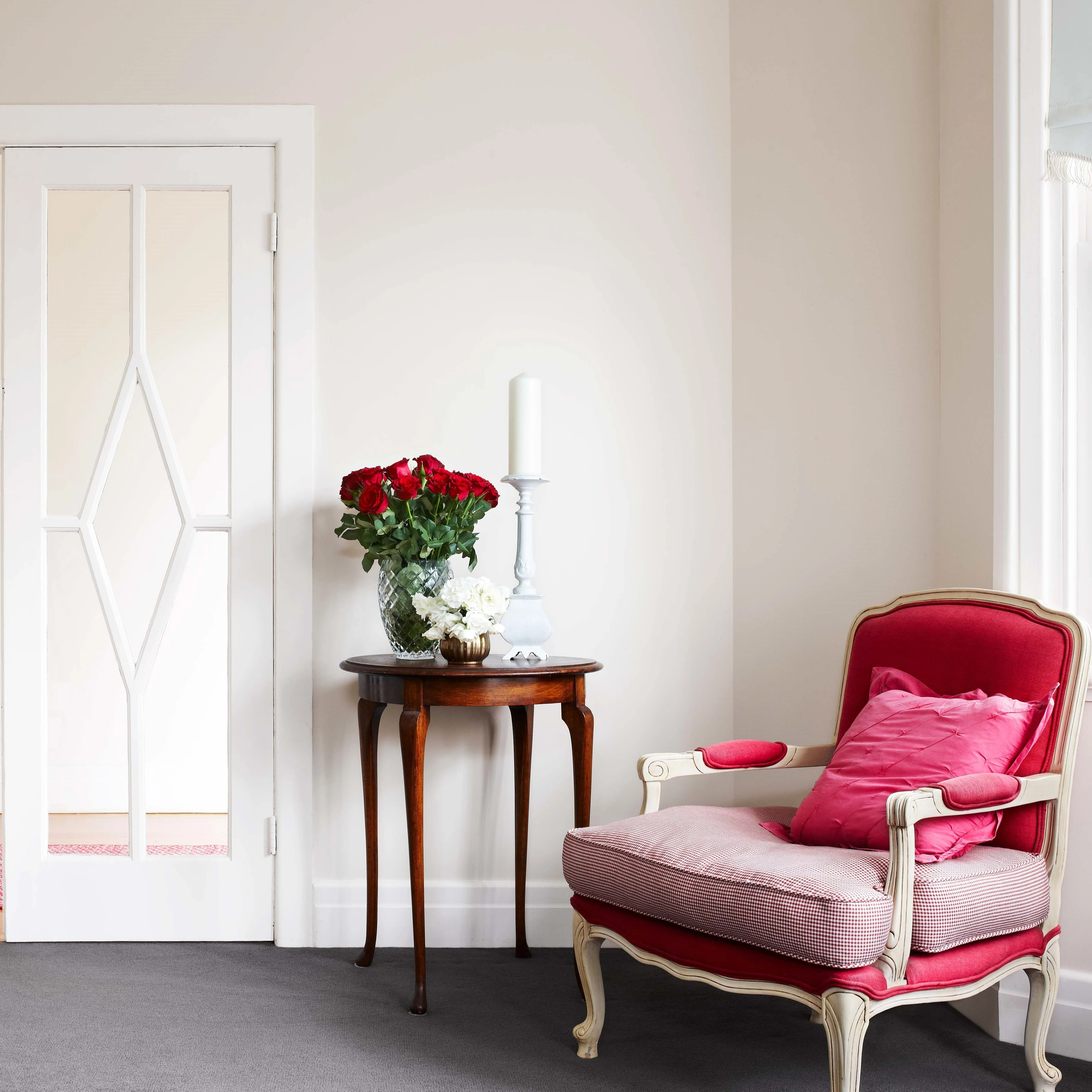 Cream living room with pink chair
