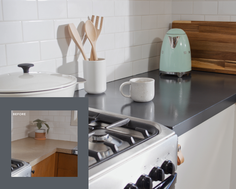 corner kitchen bench with green kettle, wooden chopping board, stove, dutch oven, mug and utensils