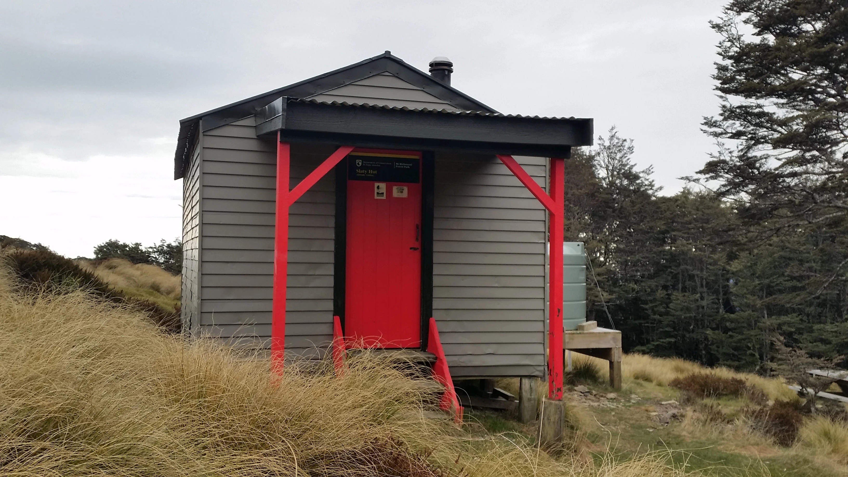 Slaty Hut is grey with a bright red feature door