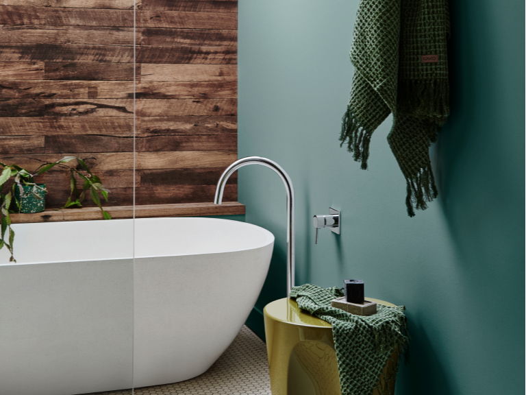 Bathroom with timber wall and green wall and freestanding bath