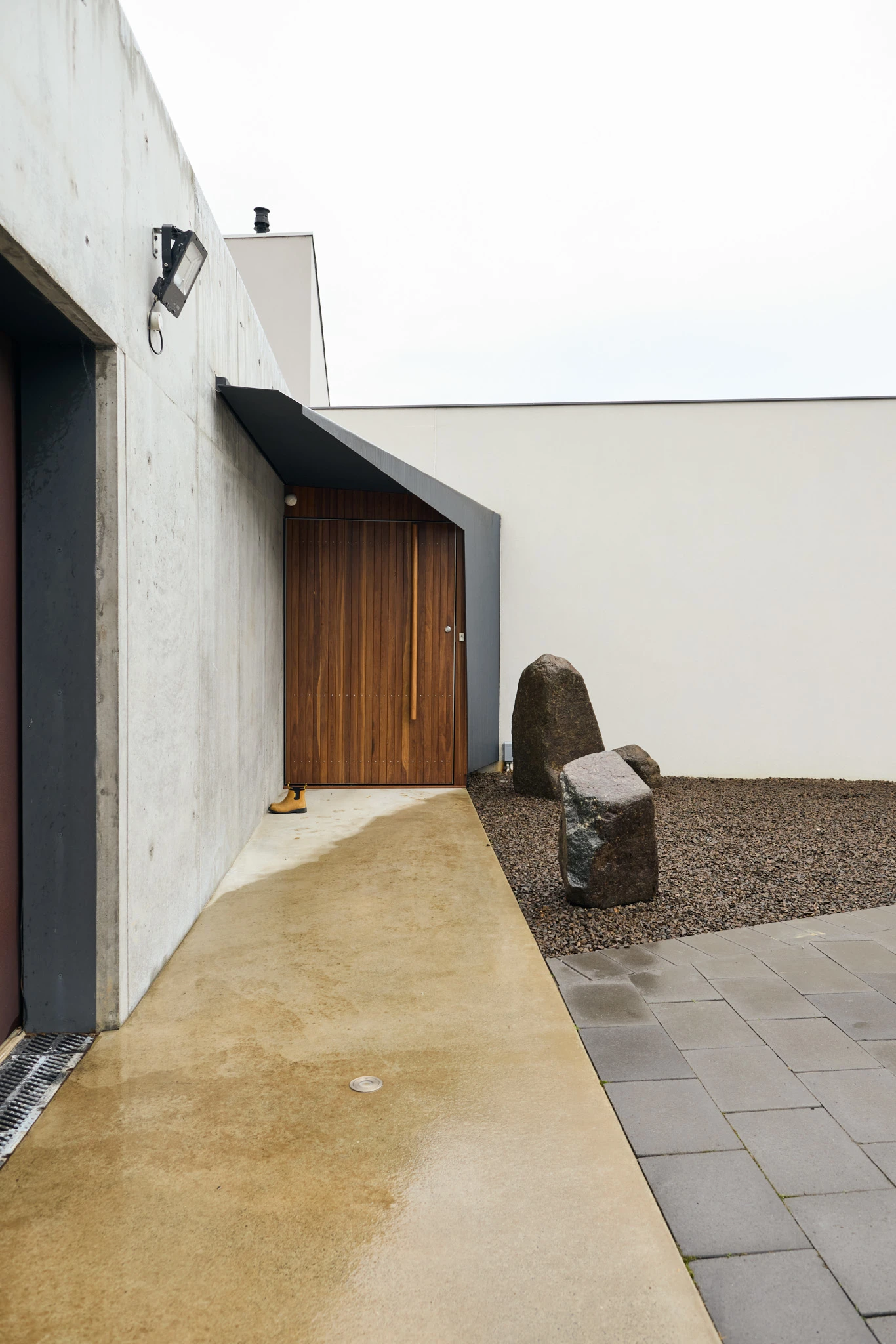 Timber front door of modern concrete house