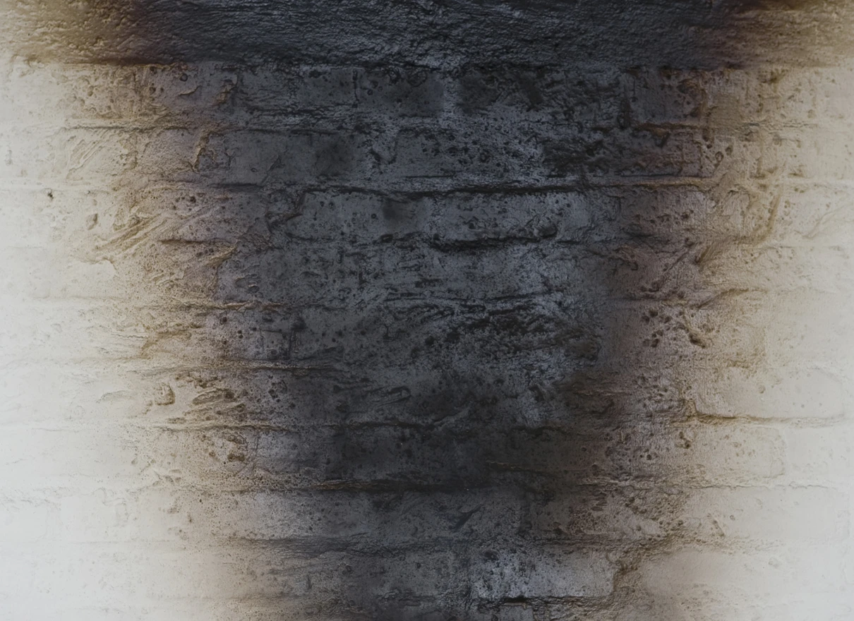 smoke stain on white brick wall